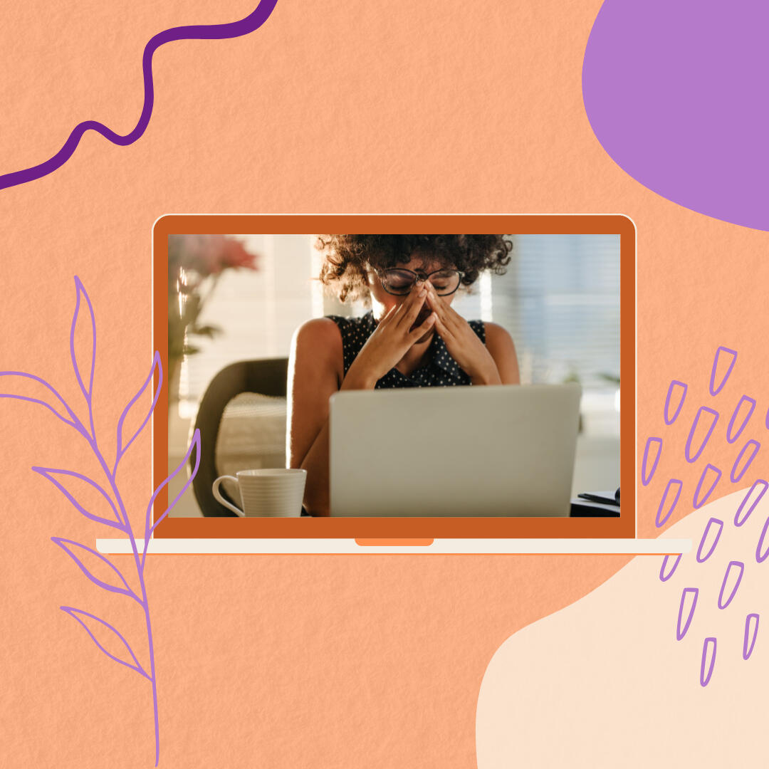 A woman rubbing her eyes at her laptop, overwhelmed